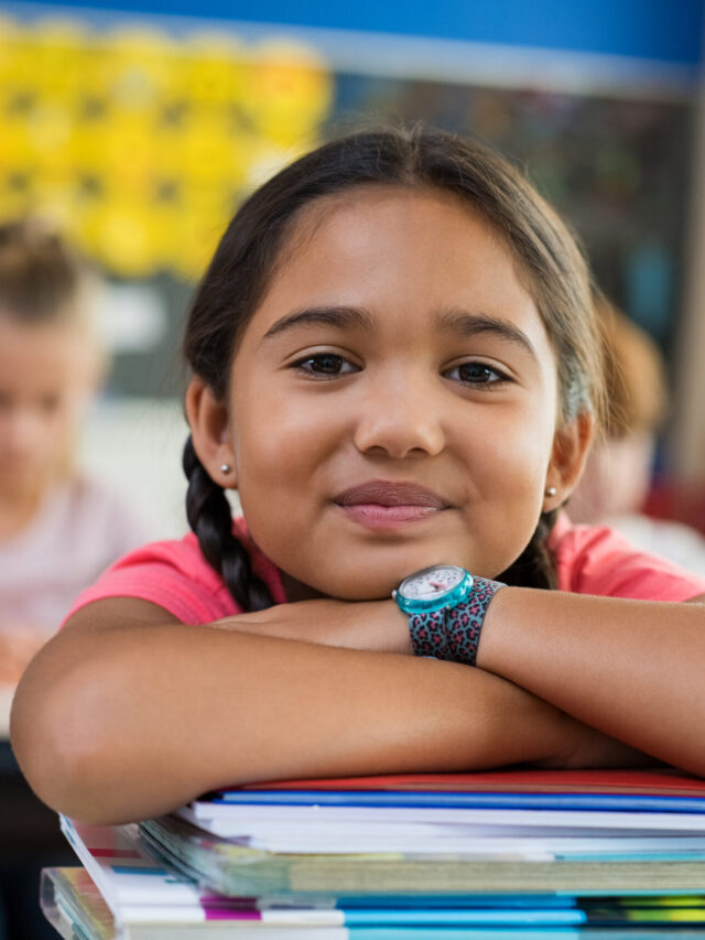 Hispanic girl with chin on books